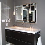 This contemporary bathroom vanity appears to float, as it sports a "stainless" laminate kickplate which reflects the tile floor.