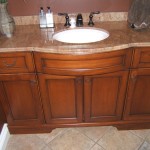 This custom vanity shows off a beautiful granite countertop and curved bow front cabinet.