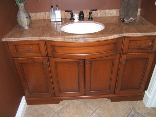 This custom vanity shows off a beautiful granite countertop and curved bow front cabinet.